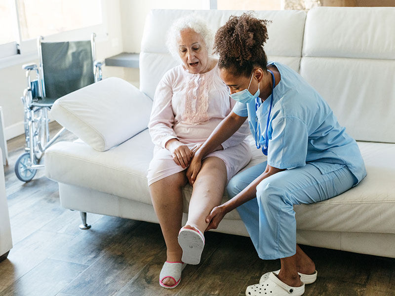 nurse helping old age women